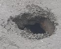 Помимо того что дороги нет так ещё и земля проваливается, власти пишут отписки