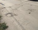 Дорожное покрытие разрушено, ширина дороги не позволяет разъезжаться двум автомобилям без заезда в ямы