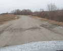 На всем протяжении участка дороги ямы, дорогу не ремонтировали с момента постройки, жители сами засыпают ямы, кто чем может